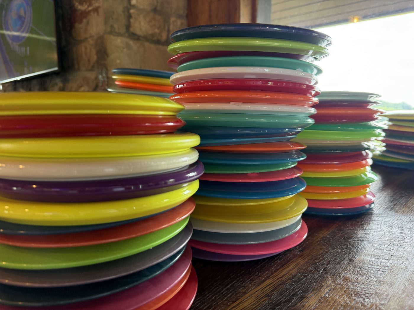 Stacks of colorful Innova disc golf discs for sale at the Oglebay driving range